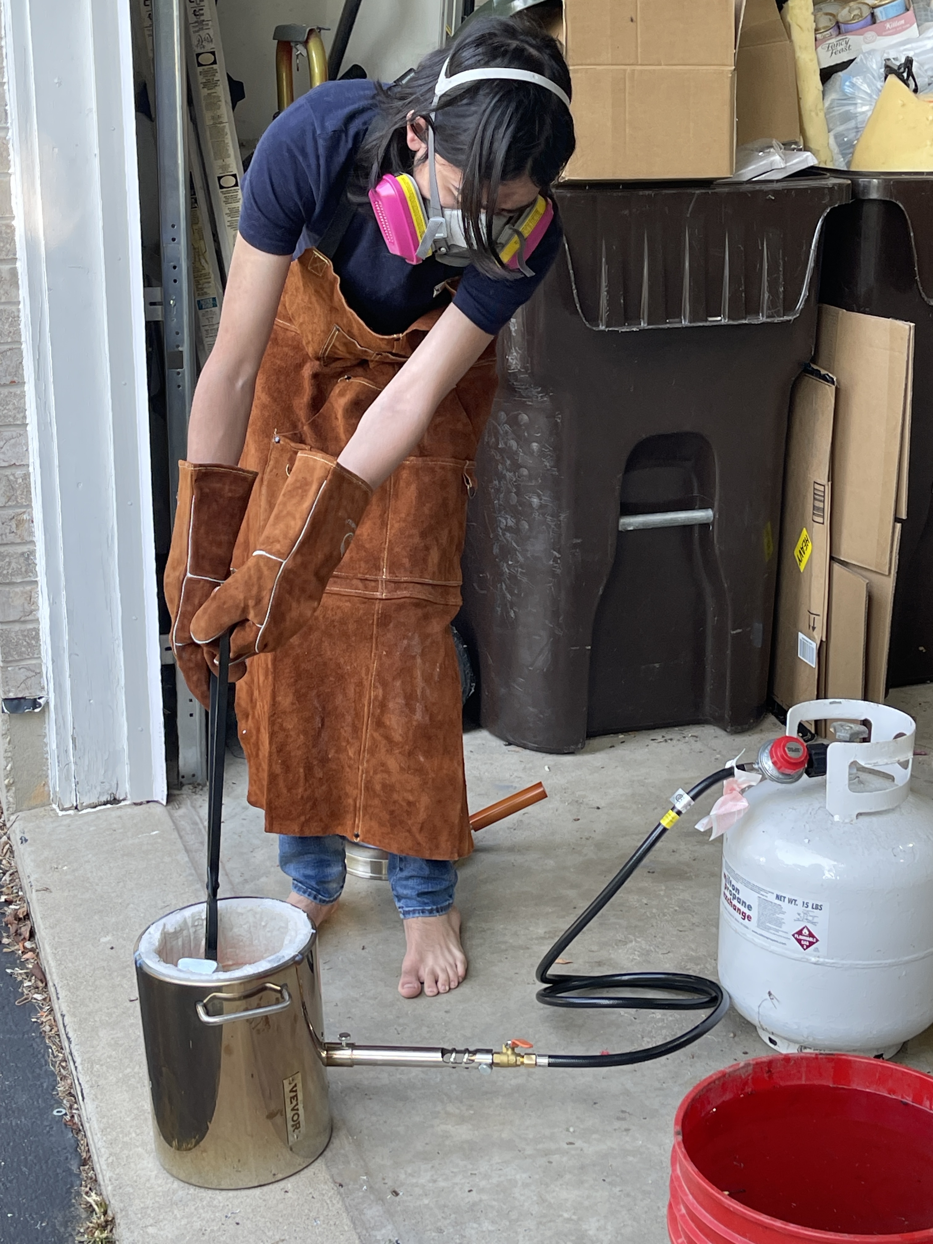 Alin melting metal in a propane foundry furnace